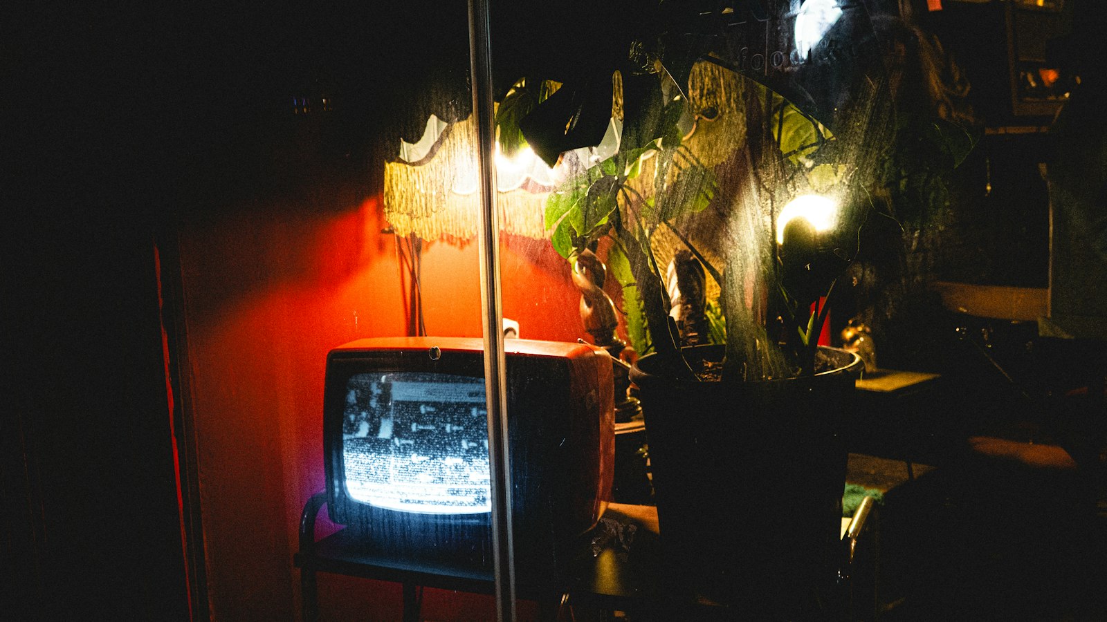 A television glowing in a dark living room at night
